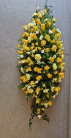 yellow and white casket spray